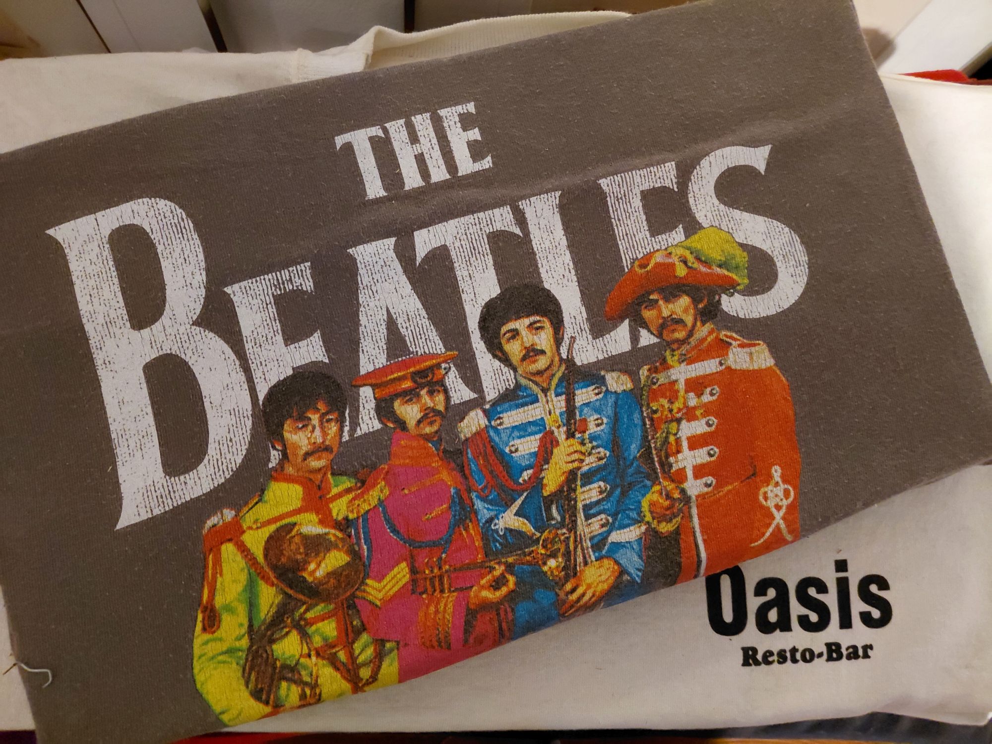 Beatles Sgt. Pepper artwork on an Oasis Resto-Bar shirt