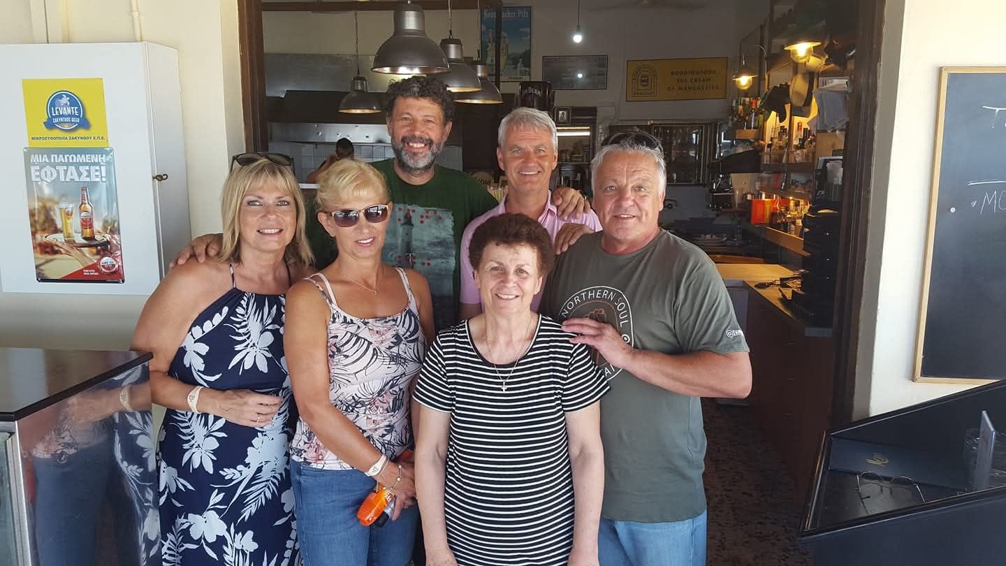Mamma Victoria with happy guests at Oasis Taverna, Alykanas